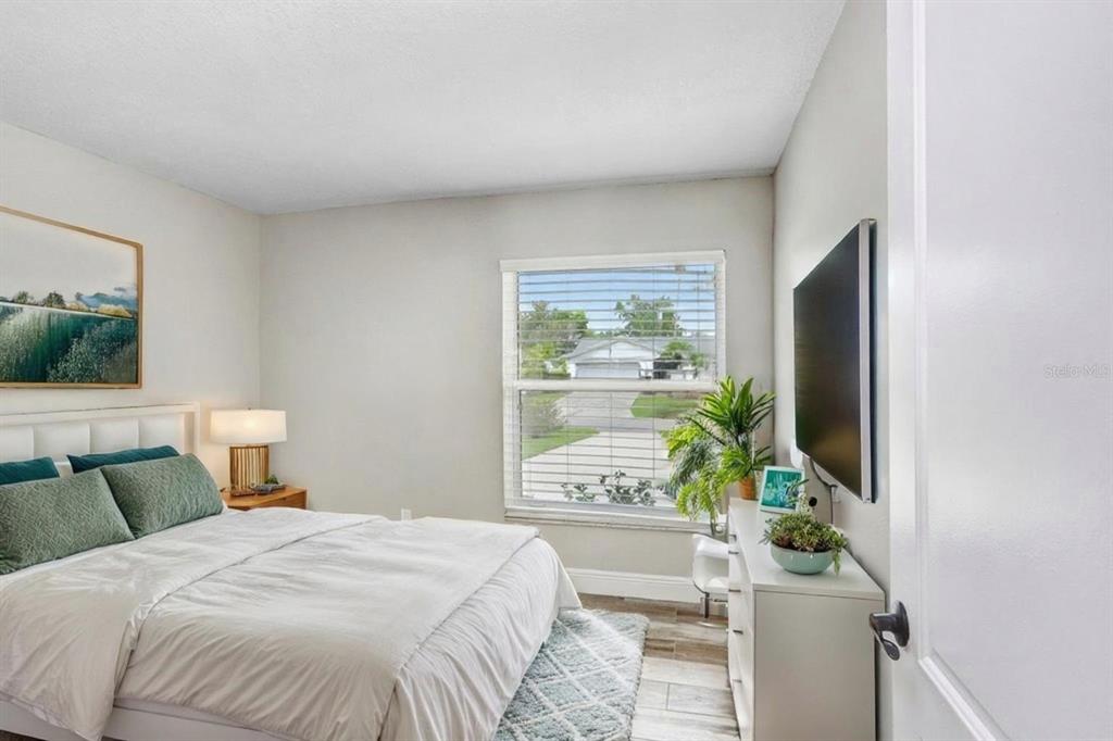 4412 Stonehenge Road Tampa, FL 33624 - Photo 22 of 33 a bedroom with a bed and a flat screen tv