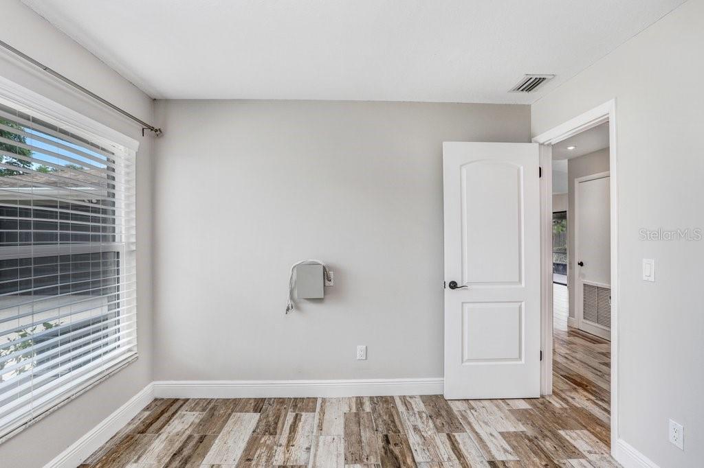 4412 Stonehenge Road Tampa, FL 33624 - Photo 23 of 33 a view of room with window and hardwood floor