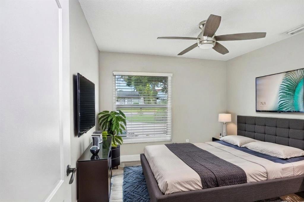 4412 Stonehenge Road Tampa, FL 33624 - Photo 24 of 33 a bedroom with a bed and ceiling fan