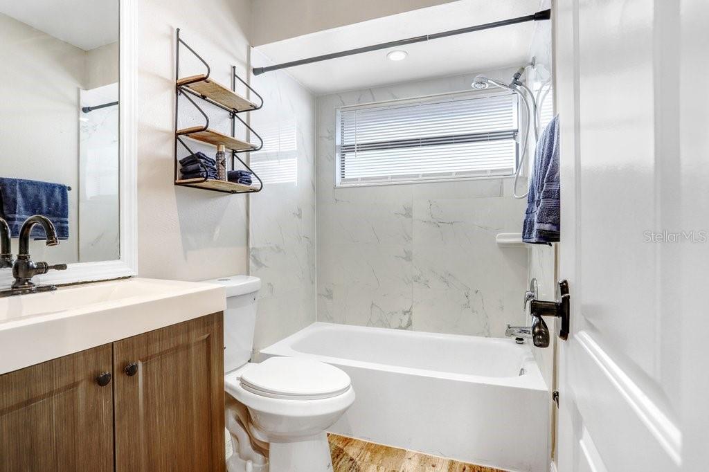 4412 Stonehenge Road Tampa, FL 33624 - Photo 26 of 33 a bathroom with a sink a toilet and shower