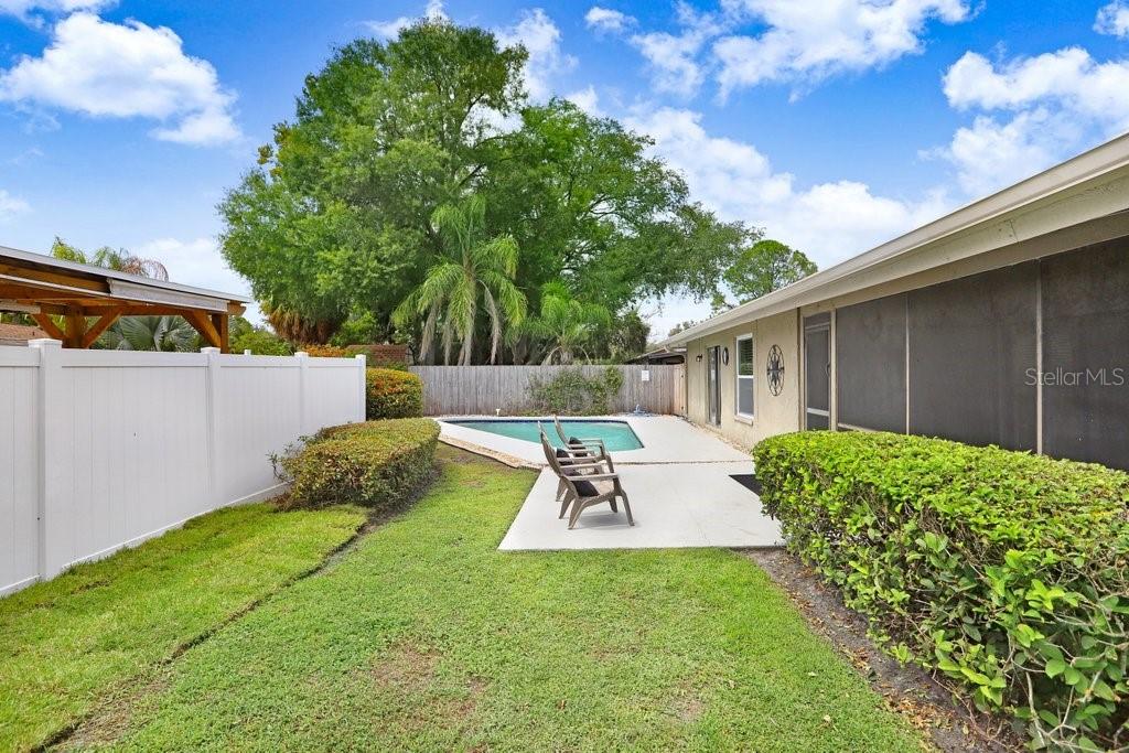 4412 Stonehenge Road Tampa, FL 33624 - Photo 29 of 33 a view of backyard with table and chairs and potted plants