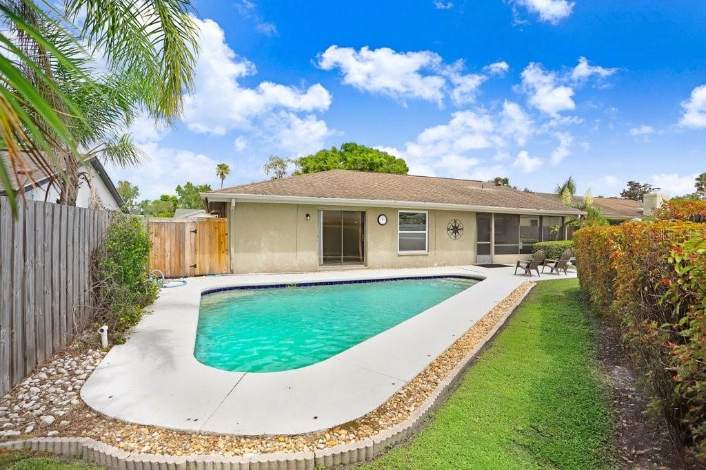 4412 Stonehenge Road Tampa, FL 33624 - Photo 33 of 33 a view of a house with swimming pool and a yard