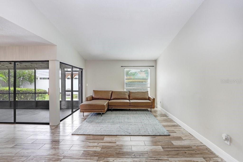 4412 Stonehenge Road Tampa, FL 33624 - Photo 5 of 33 a living room with furniture and a rug