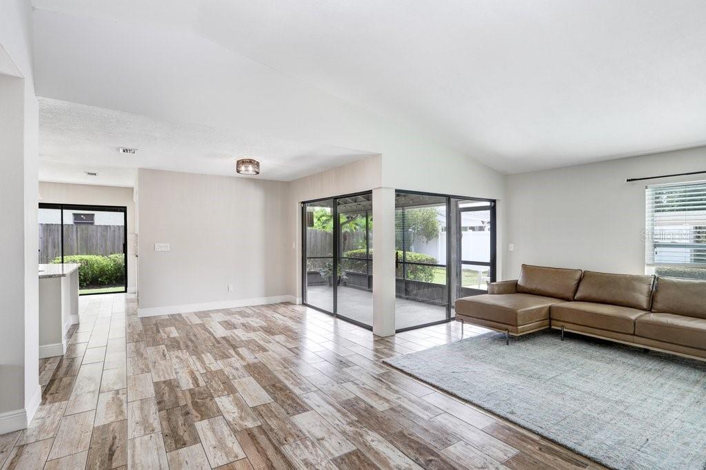 4412 Stonehenge Road Tampa, FL 33624 - Photo 6 of 33 a living room with furniture window and wooden floor