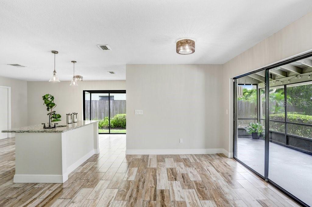 4412 Stonehenge Road Tampa, FL 33624 - Photo 9 of 33 a view of a kitchen with wooden floor and outdoor space