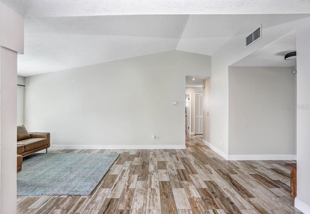 4412 Stonehenge Road Tampa, FL 33624 - Photo 10 of 33 a view of room with wooden floor and chair