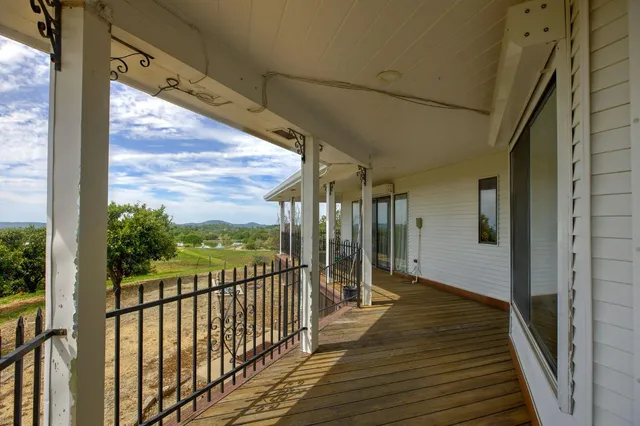 a view of a balcony with wooden floor
