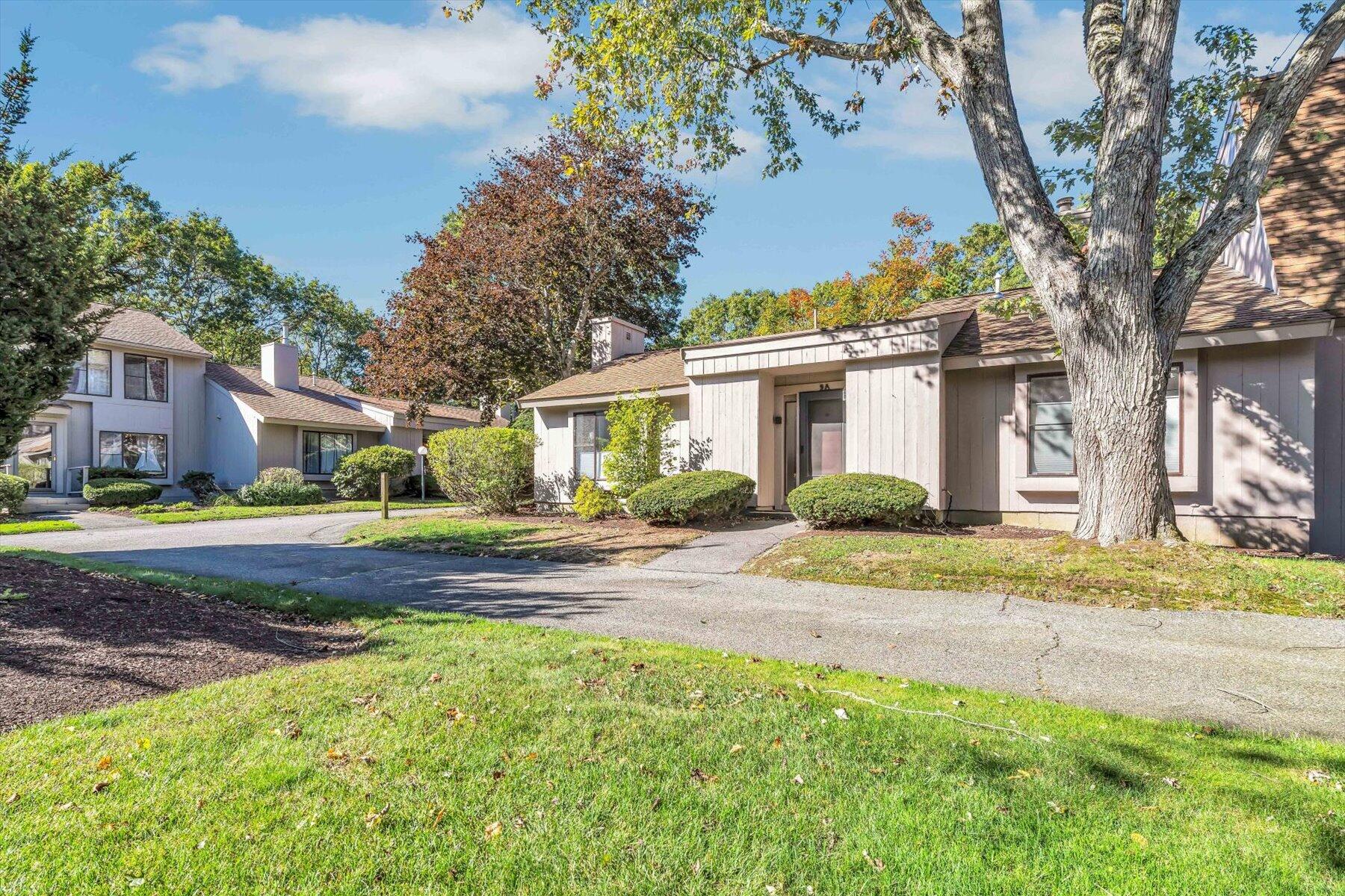 481 Buck Island Road, Unit 9AA West Yarmouth, MA 02673 - Photo 2 of 41 a view of a yard in front of a house with large tree