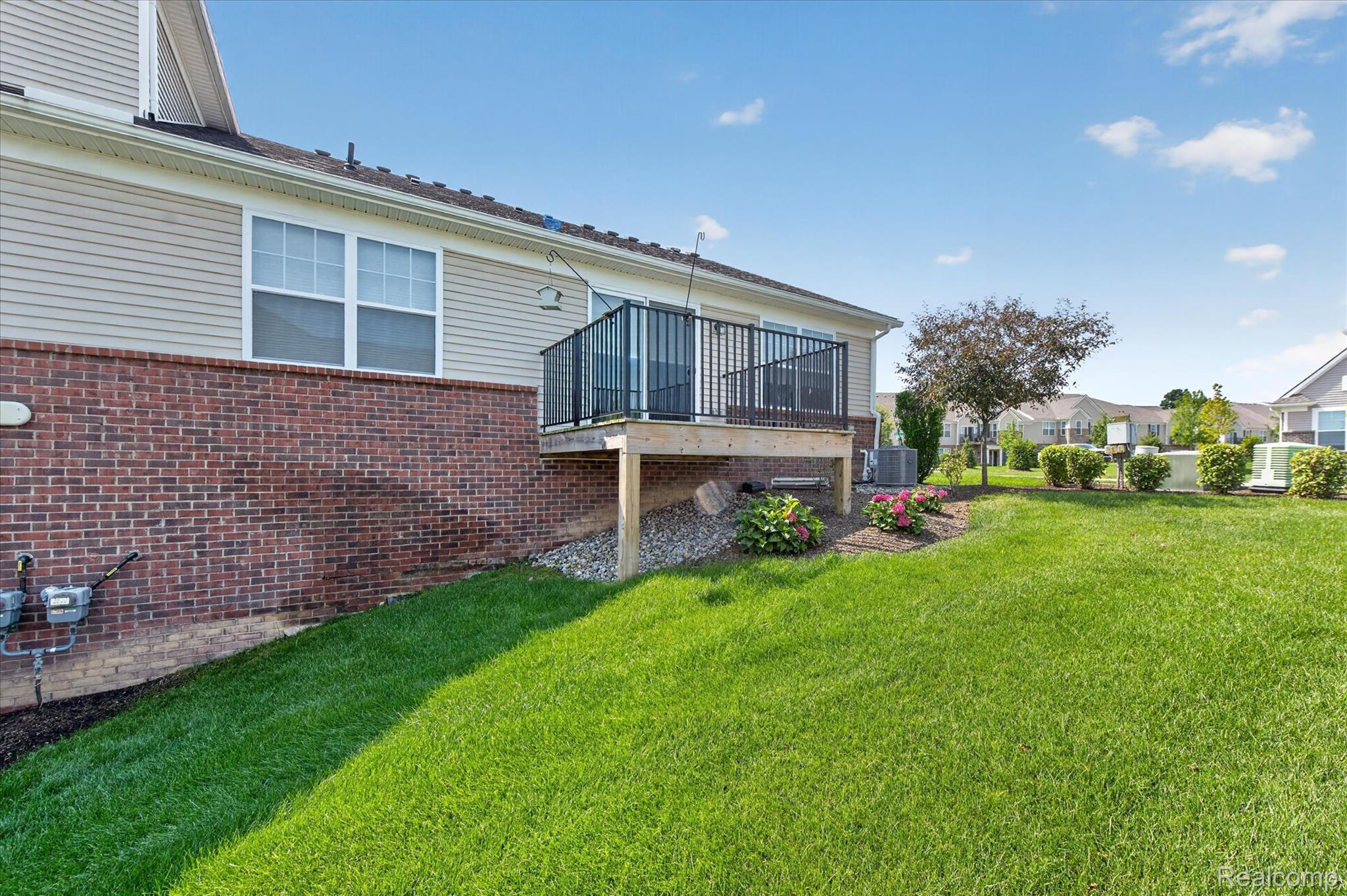 9911 Ridge Run Street Howell, MI 48855 - Photo 26 of 35 Rear exterior with elevated deck and landscaped grounds.