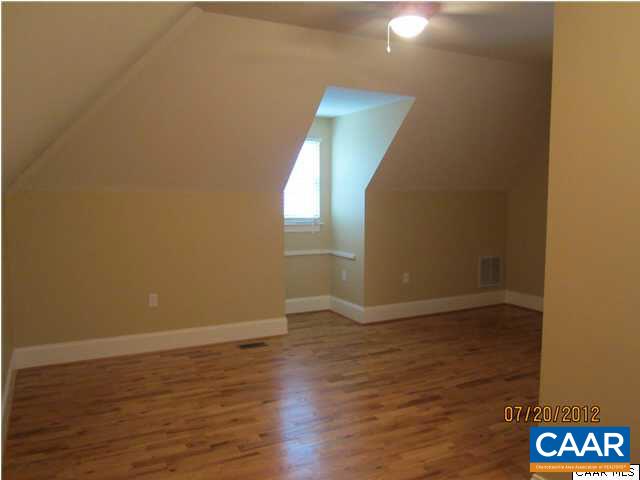 2410 Wakefield Road Charlottesville, VA 22901 - Photo 16 of 32 a view of an empty room with wooden floor and a window