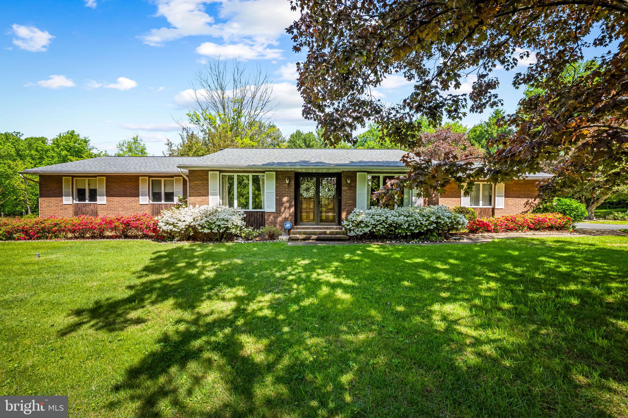 6516 Lewis Road Baldwin, MD 21013 - Photo 1 of 11 a front view of a house with a yard table and chairs