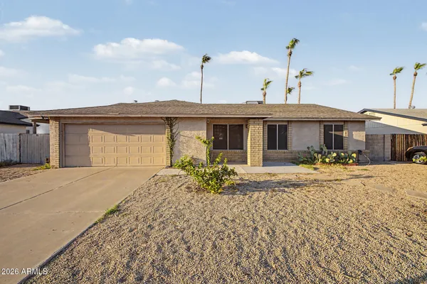 a front view of a house with yard and seating space