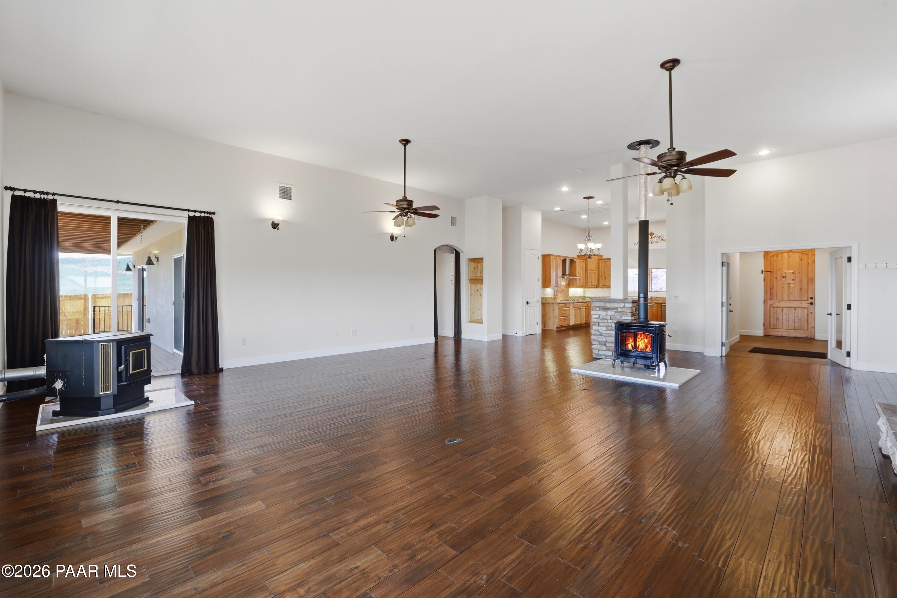 15975 Pandy Lane Dewey, AZ 86327 - Photo 11 of 39 a view of a room with wooden floor staircase and a kitchen
