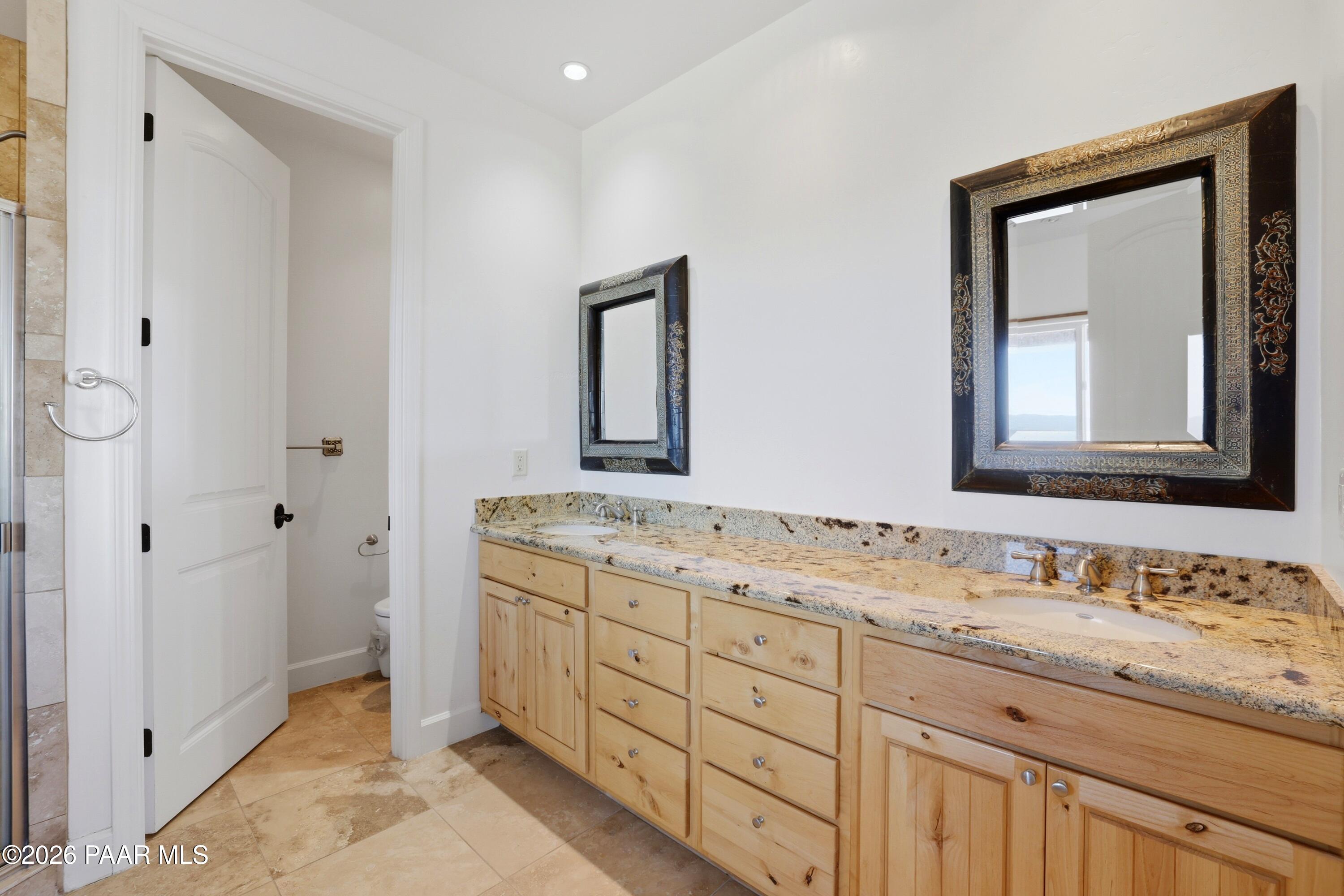 15975 Pandy Lane Dewey, AZ 86327 - Photo 22 of 39 a bathroom with a granite countertop sink vanity and mirror