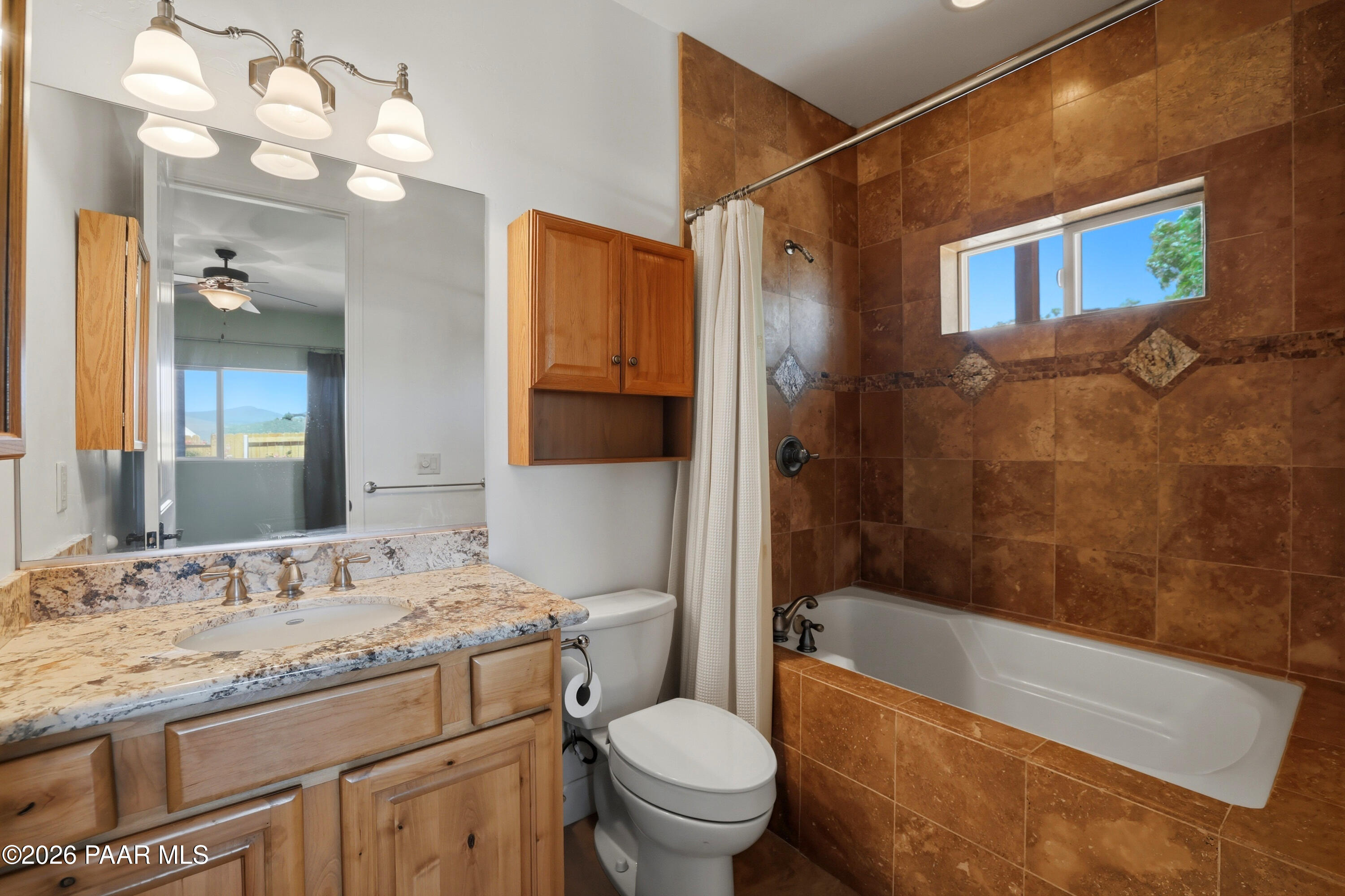 15975 Pandy Lane Dewey, AZ 86327 - Photo 29 of 39 a bathroom with a granite countertop sink a mirror a bathtub and a toilet