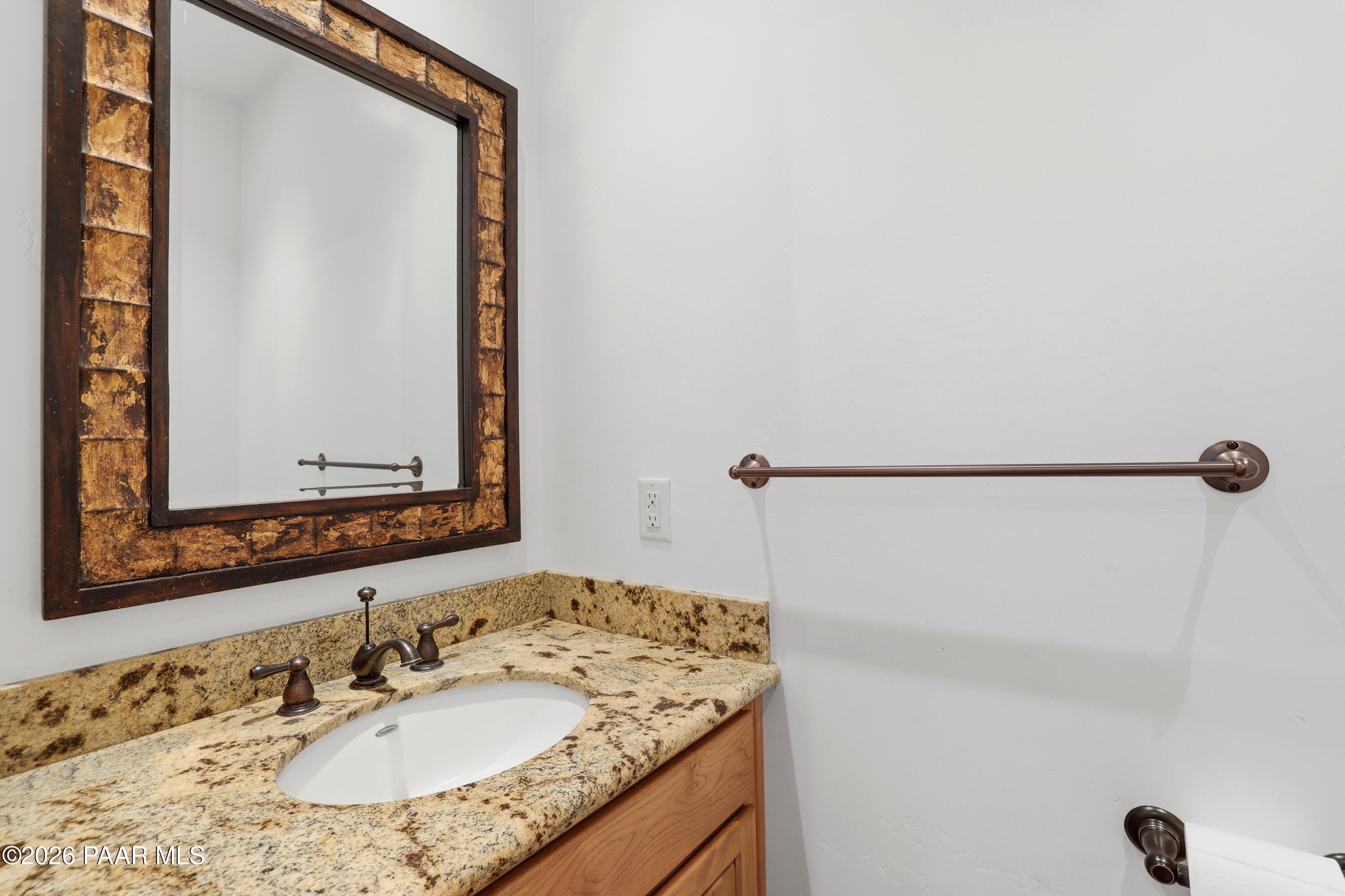 15975 Pandy Lane Dewey, AZ 86327 - Photo 30 of 39 a bathroom with a granite countertop sink and a mirror