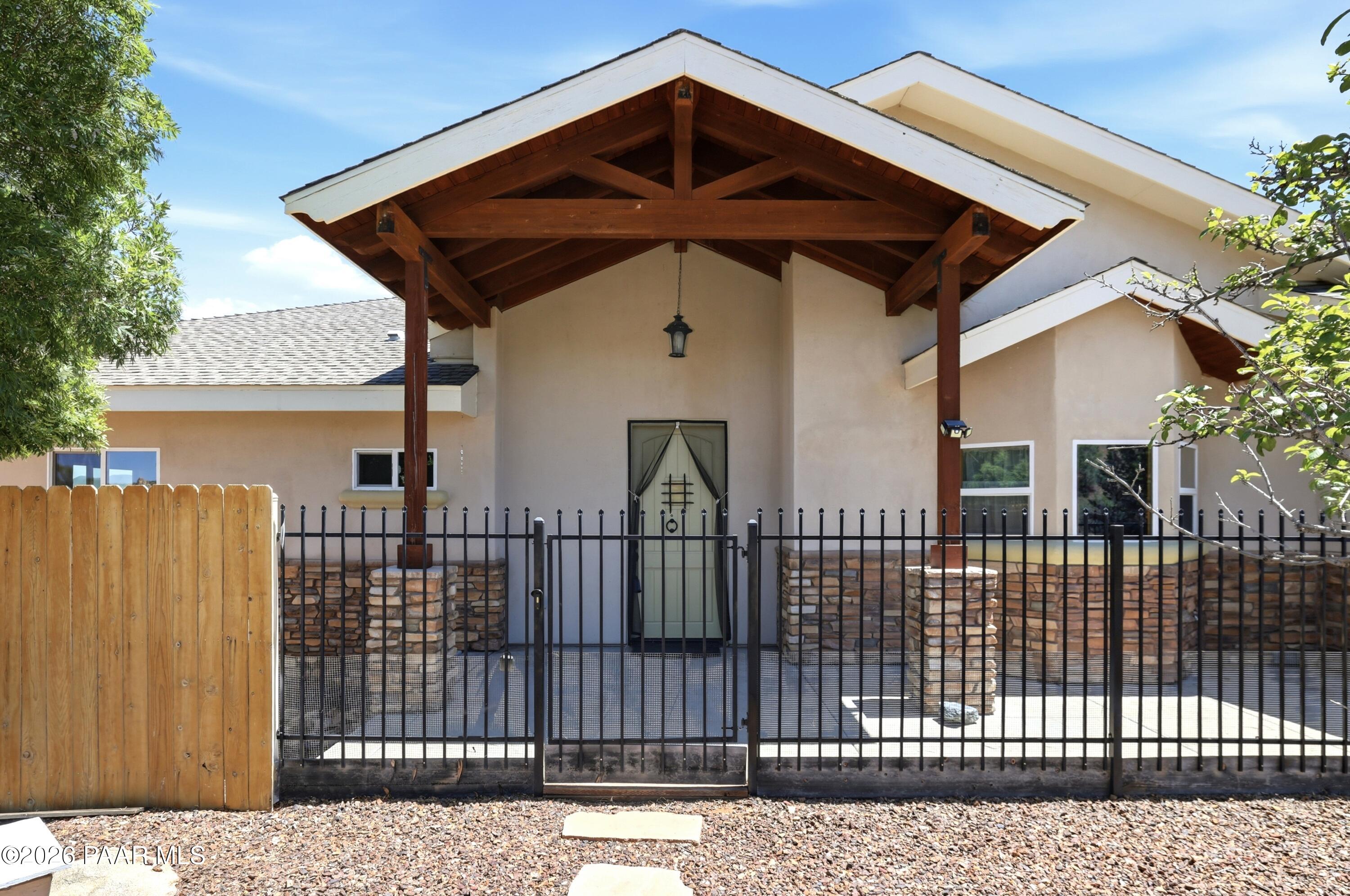 15975 Pandy Lane Dewey, AZ 86327 - Photo 6 of 39 a front view of a house with a wooden fence