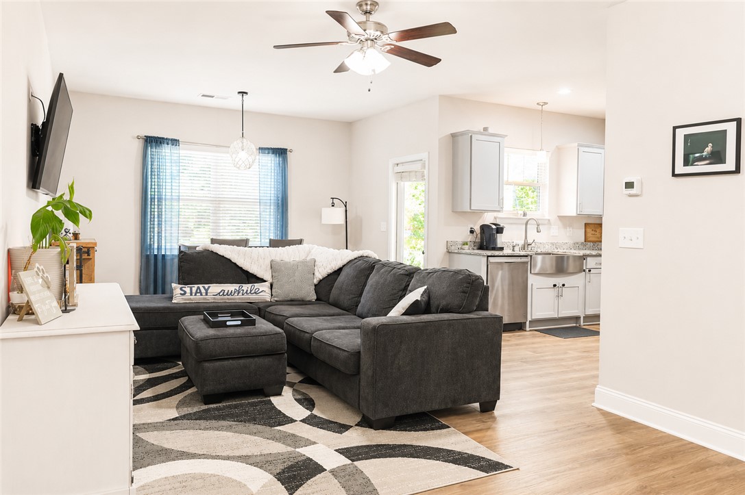 102 Ventura Street Anderson, SC 29621 - Photo 7 of 24 An inviting open-concept living area seamlessly connects to the kitchen, offering both comfort and functionality.