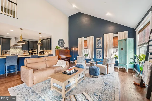 a living room with furniture and a book shelf