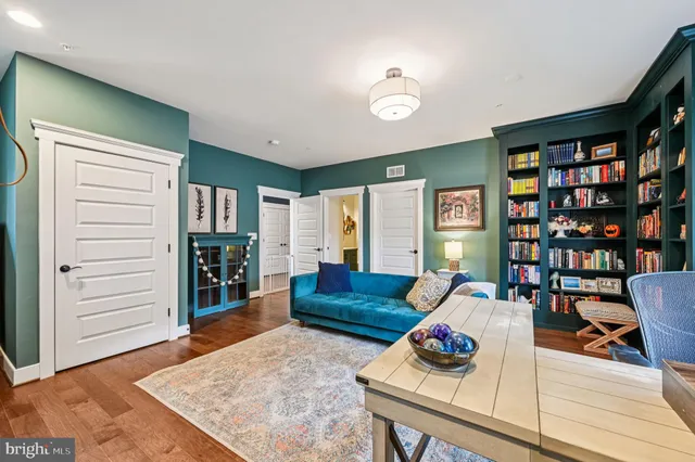 a bedroom with a bed a couch and dresser