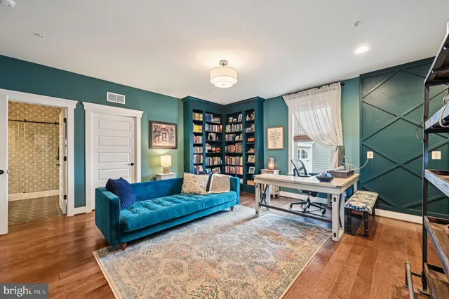 a living room with furniture and kitchen view