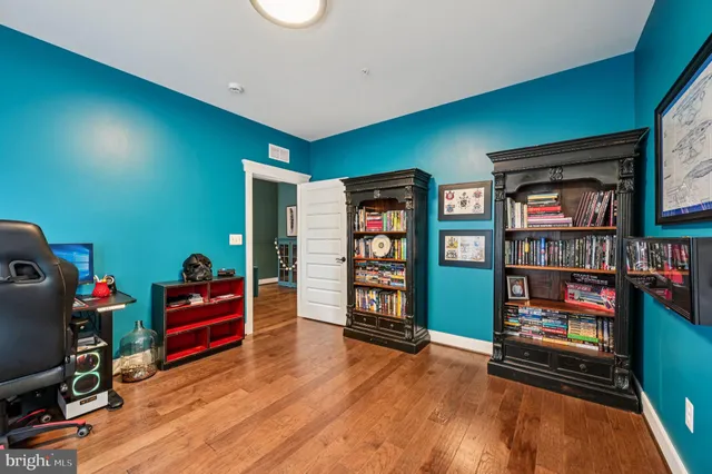 a living room with furniture a flat screen tv and a window