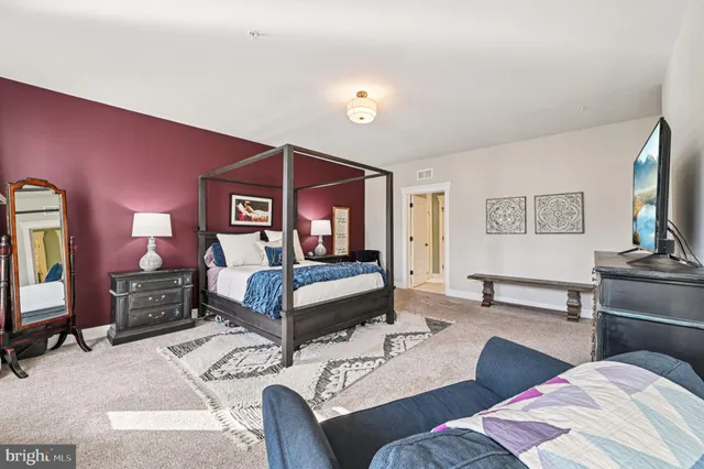 a bedroom with a bed and a chair