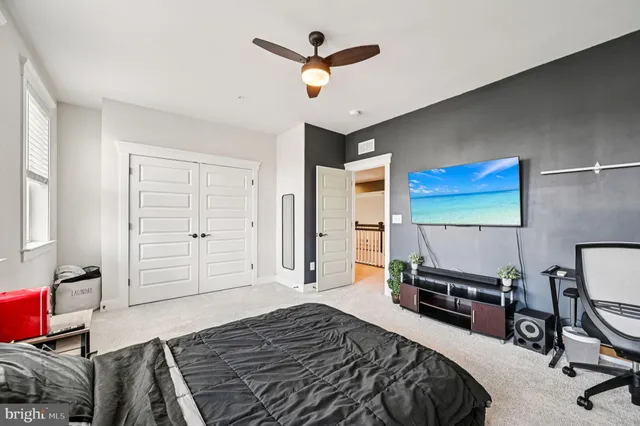 a bedroom with furniture and a flat screen tv