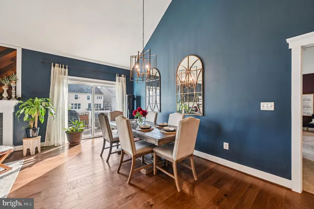 a living room with fireplace furniture and a large window