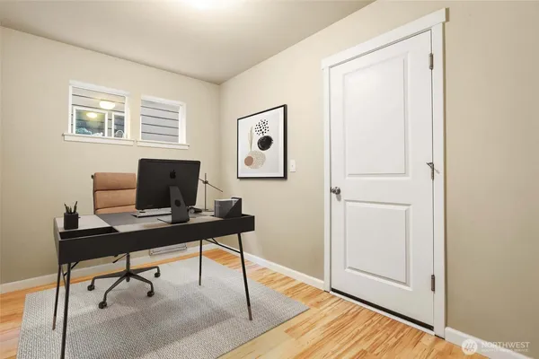 a view of a workspace with furniture and a window