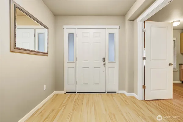 a view of an empty room with wooden floor