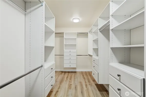 a view of walk in closet with empty racks