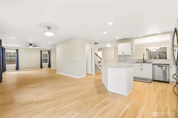 a view of large kitchen with a sink cabinets and stainless steel appliances