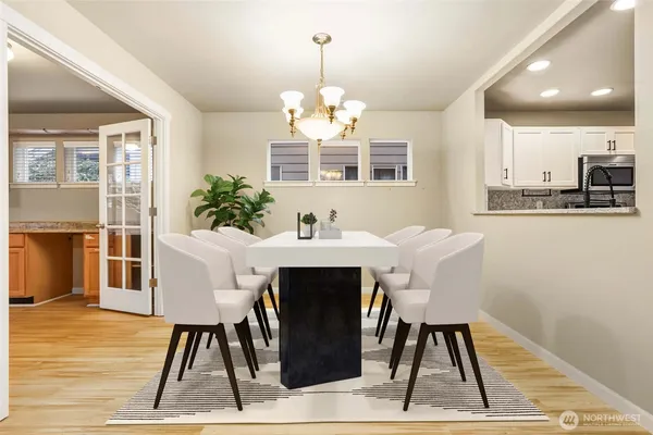 a dining room with wooden floor and a chandelier