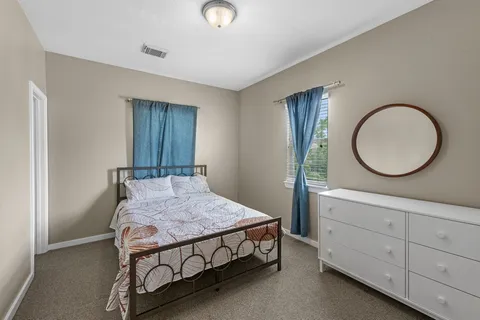 a bedroom with a bed and a dresser