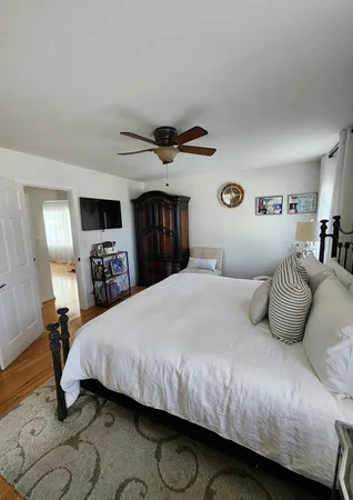 a bedroom with a large bed and a tv