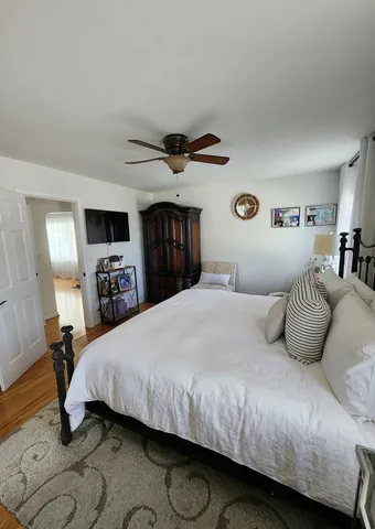 a bedroom with a large bed and a tv