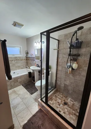 a bathroom with a glass shower door