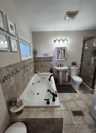 a bathroom with a sink toilet and mirror