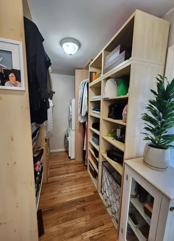 a view of walk in closet with clothes and shoes
