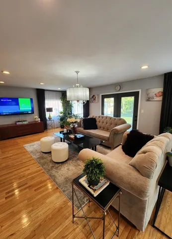 a living room with furniture and a wooden floor