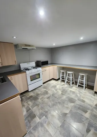 a kitchen with stainless steel appliances a stove a sink and a refrigerator