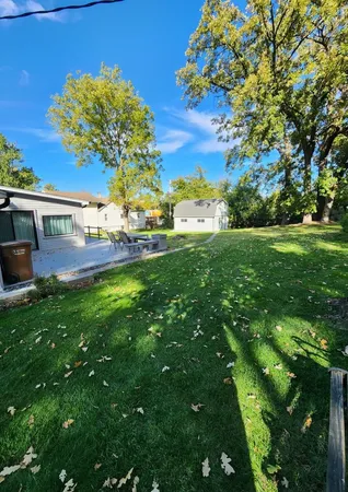 a view of yard with swimming pool and green space