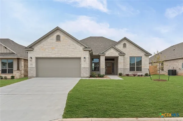 a front view of a house with a yard and garage