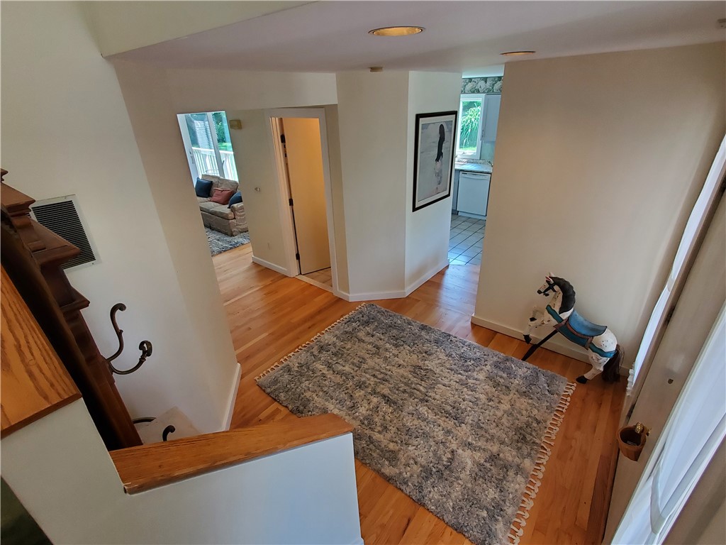 15 Hammersmith Road, Unit 33 Newport, RI 02840 - Photo 6 of 49 Foyer view from stairs to living room, half bath, kitchen and front door.