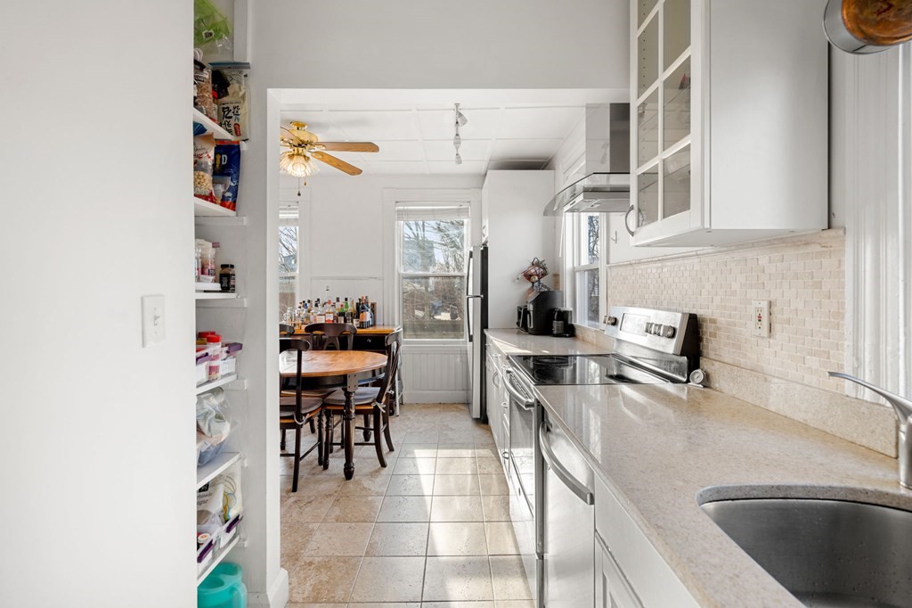 98 Pine Street Swampscott, MA 01907 - Photo 11 of 37 a kitchen with stainless steel appliances granite countertop a sink and a refrigerator