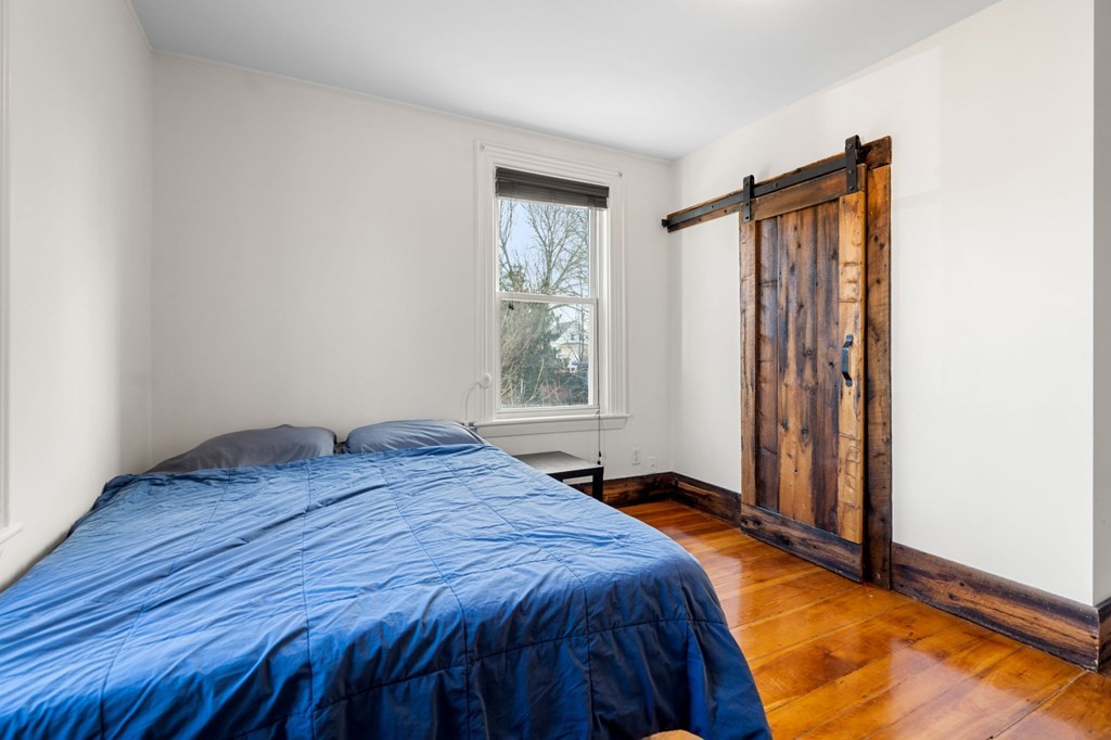 98 Pine Street Swampscott, MA 01907 - Photo 15 of 37 a bed sitting in a bedroom next to a window