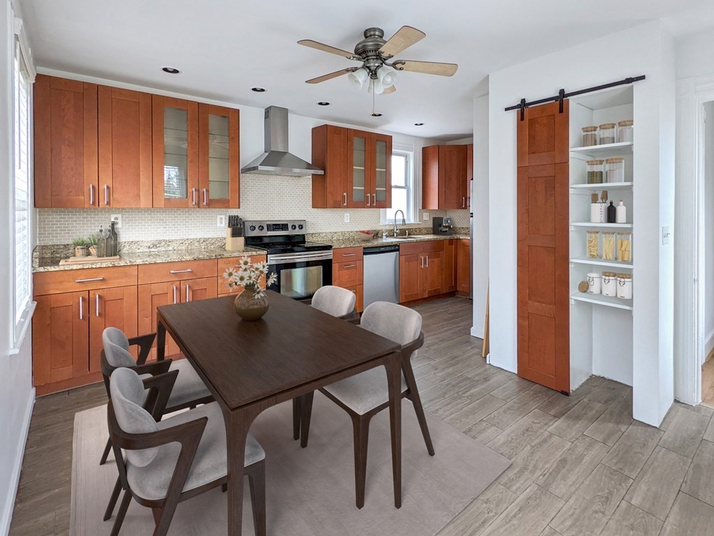 98 Pine Street Swampscott, MA 01907 - Photo 18 of 37 a kitchen with stainless steel appliances granite countertop a stove a refrigerator a sink a dining table and chairs with wooden floor
