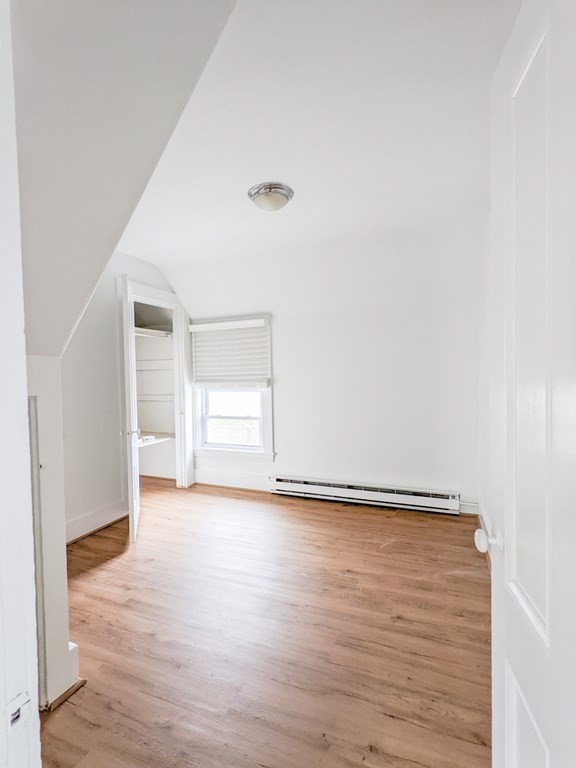 98 Pine Street Swampscott, MA 01907 - Photo 21 of 37 a view of an empty room with wooden floor and a window