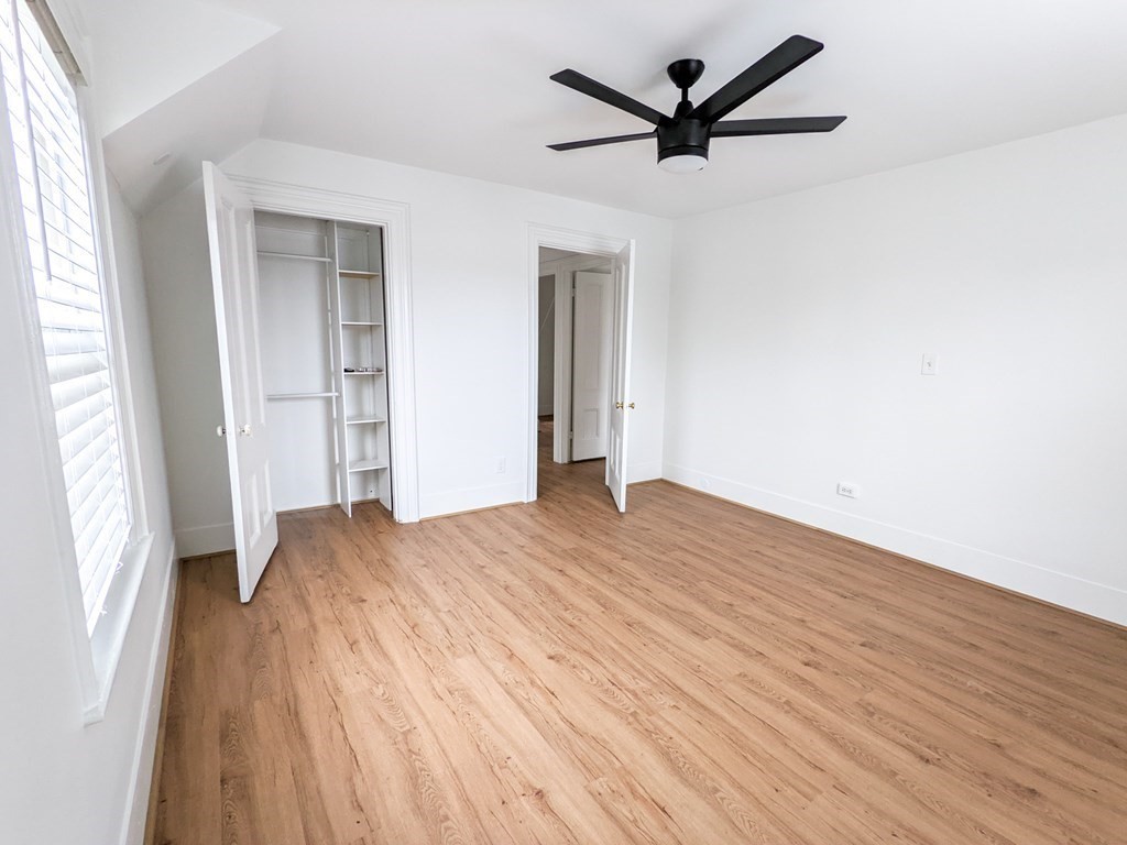 98 Pine Street Swampscott, MA 01907 - Photo 22 of 37 an empty room with wooden floor and a ceiling fan